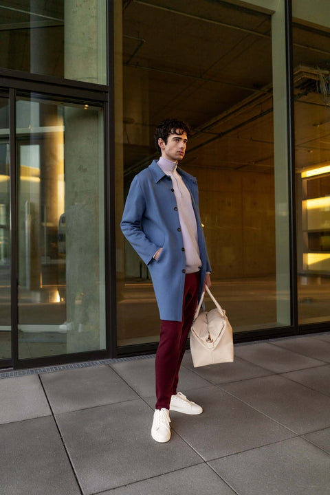 Model wearing the Coat (Pre-order) made of organic cotton and cashmere in stone blue.