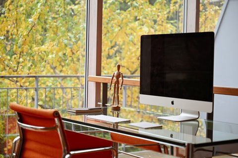 home office setup with orange chair and imac